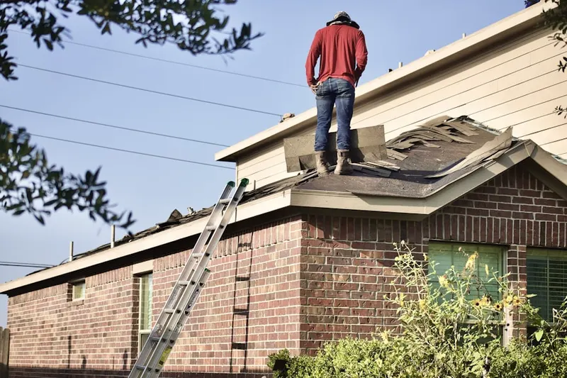Professional roofer working on a residential roof in White Marsh Station